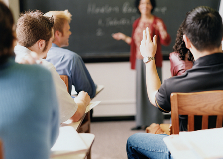 Student raising hand in a college class