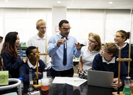science teacher giving a lab demonstration to students